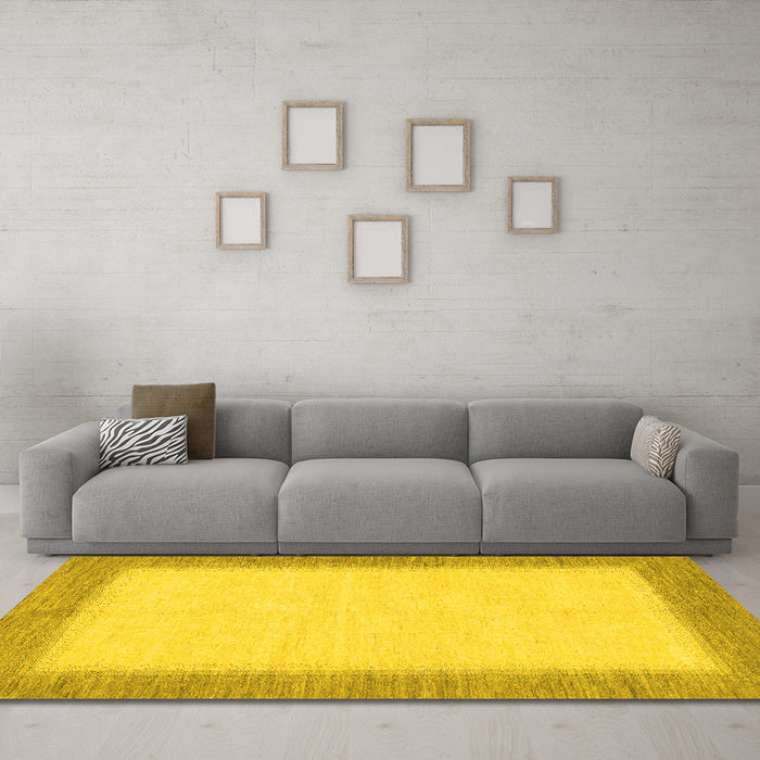 Machine Washable Solid Yellow Modern Rug in a Living Room, wshabs1424yw