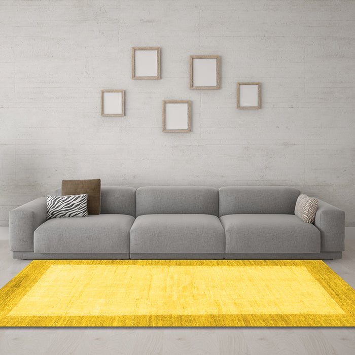 Machine Washable Solid Yellow Modern Rug in a Living Room, wshabs1458yw
