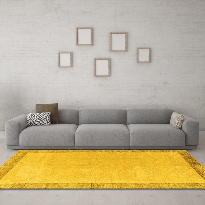 Machine Washable Solid Yellow Modern Rug in a Living Room, wshabs4306yw
