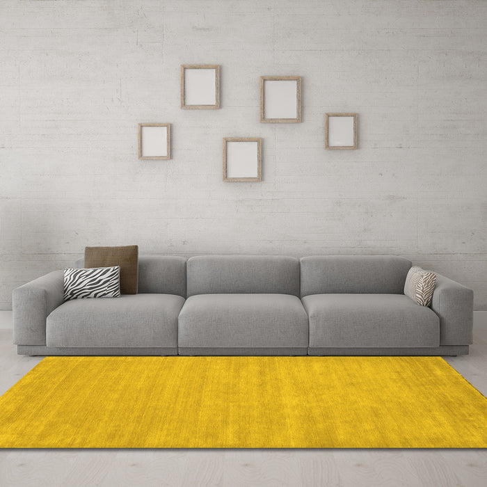 Machine Washable Solid Yellow Modern Rug in a Living Room, wshcon112yw