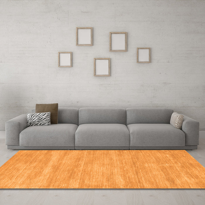 Machine Washable Solid Orange Modern Area Rugs in a Living Room, wshcon125org