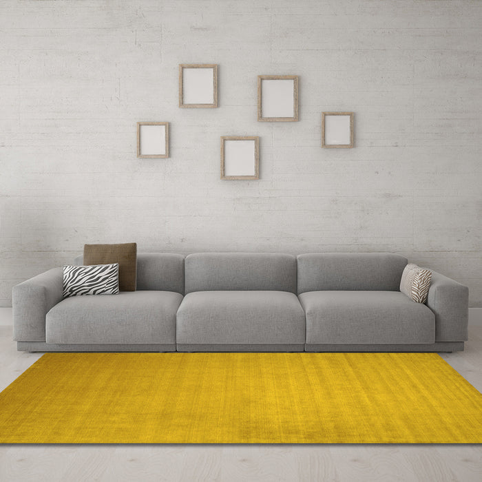 Machine Washable Solid Yellow Modern Rug in a Living Room, wshcon140yw