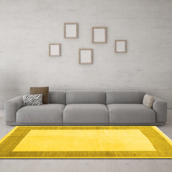 Machine Washable Solid Yellow Modern Rug in a Living Room, wshcon1522yw
