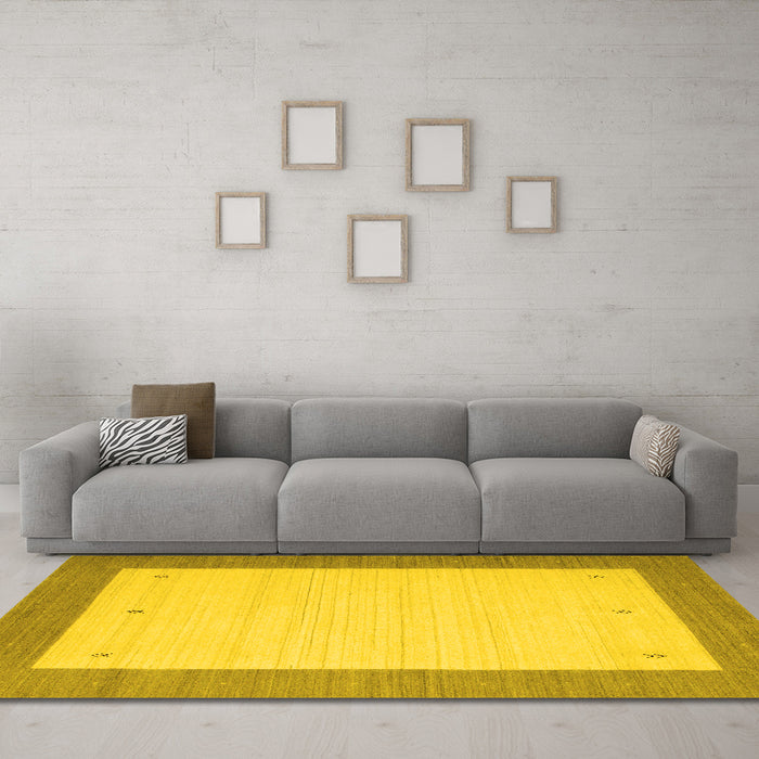 Machine Washable Solid Yellow Modern Rug in a Living Room, wshcon568yw