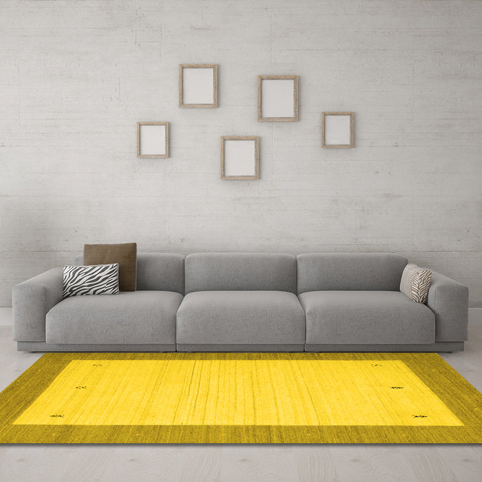 Machine Washable Solid Yellow Modern Rug in a Living Room, wshcon569yw