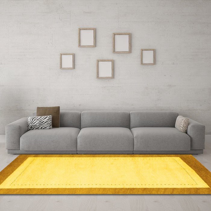 Machine Washable Solid Yellow Modern Rug in a Living Room, wshcon664yw