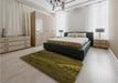 Patterned Dark Yellow Green Rug in a Bedroom, pat972org